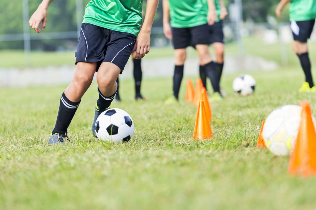 Soccer athlete participates in soccer practice drills