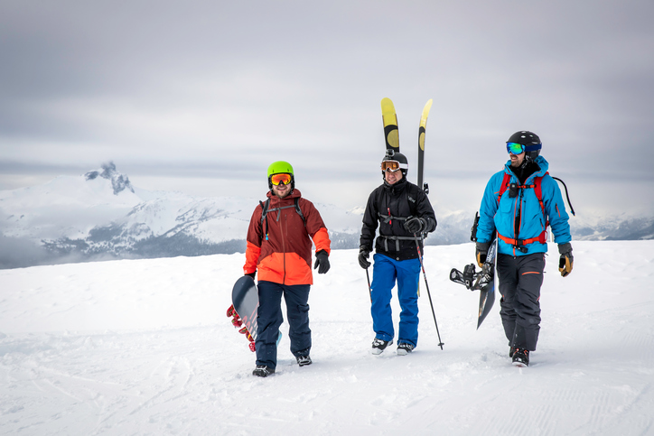 Backcountry Skier and Snowboarders on Mountain Summit