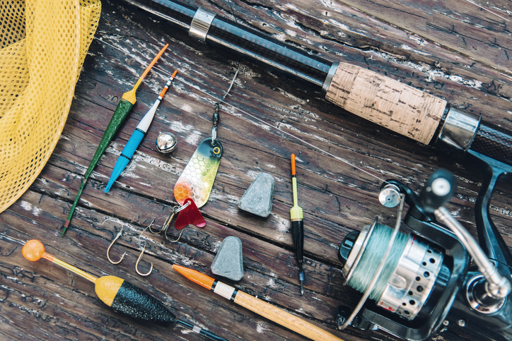 vintage fishing equipment on rustic wooden plank