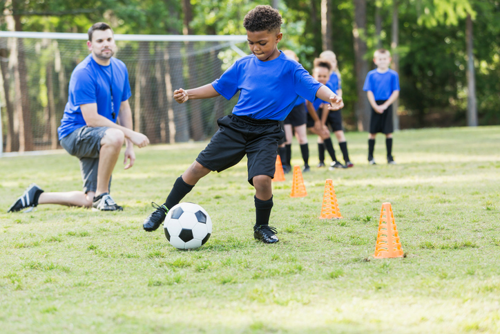 boy playing soccer