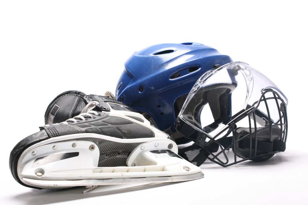 Close up of a hockey helmet and skate