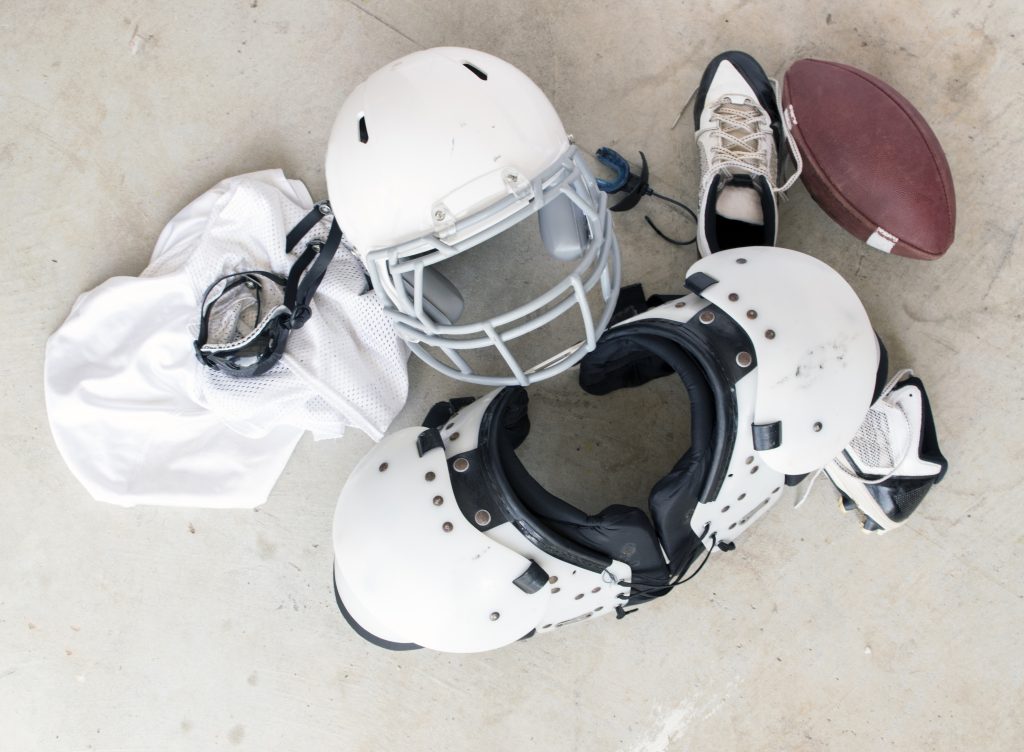 Football Safety Gear and Folded Uniform